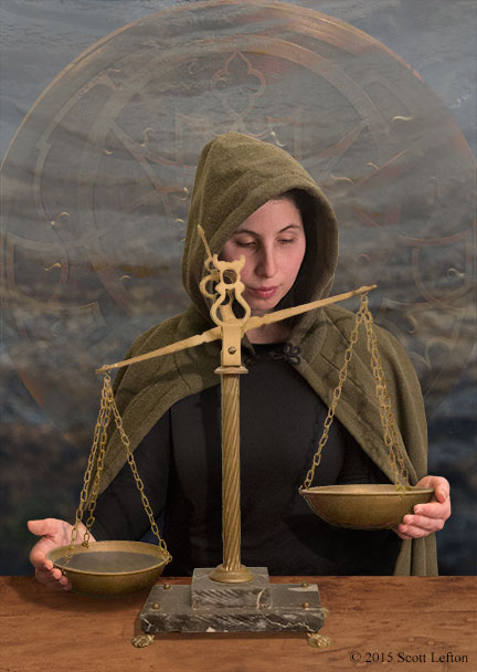 A cloaked and hooded woman stands behind a balance scale, her hands gently resting against the pans.  The lower pan is filled with liquid, the other's contents are not seen.  