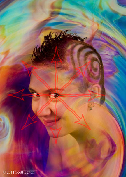 A young woman with spiral designs in her hair grins amidst rainbow swirls from behind a chaos arrow