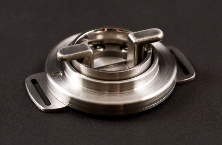 Stainless steel puzzle holding a wedding ring