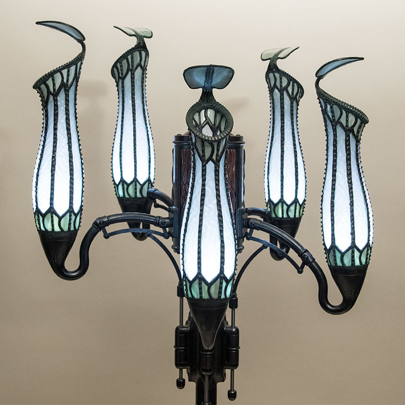 Pitcher Plant Lamp with five heads, all lit by white light to display the stained glass shades.