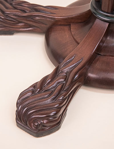 Detail of the Lamp carved mahogany foot.
